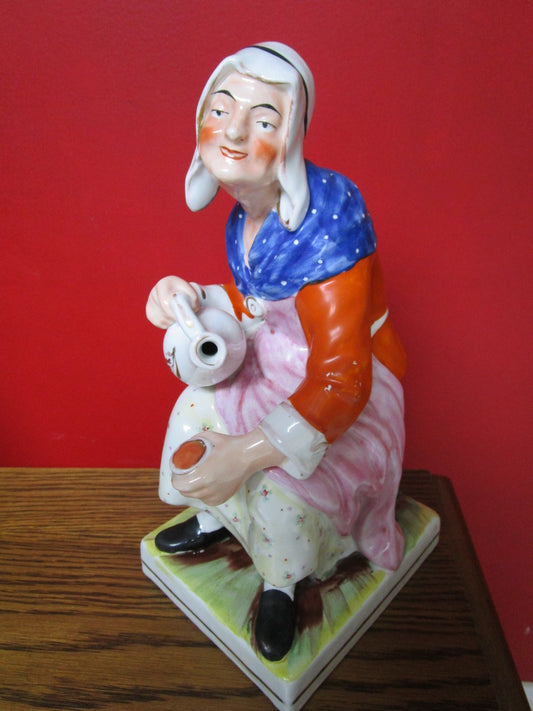 Antique Staffordshite England sculpture figurine of a lady pourring tea on cup