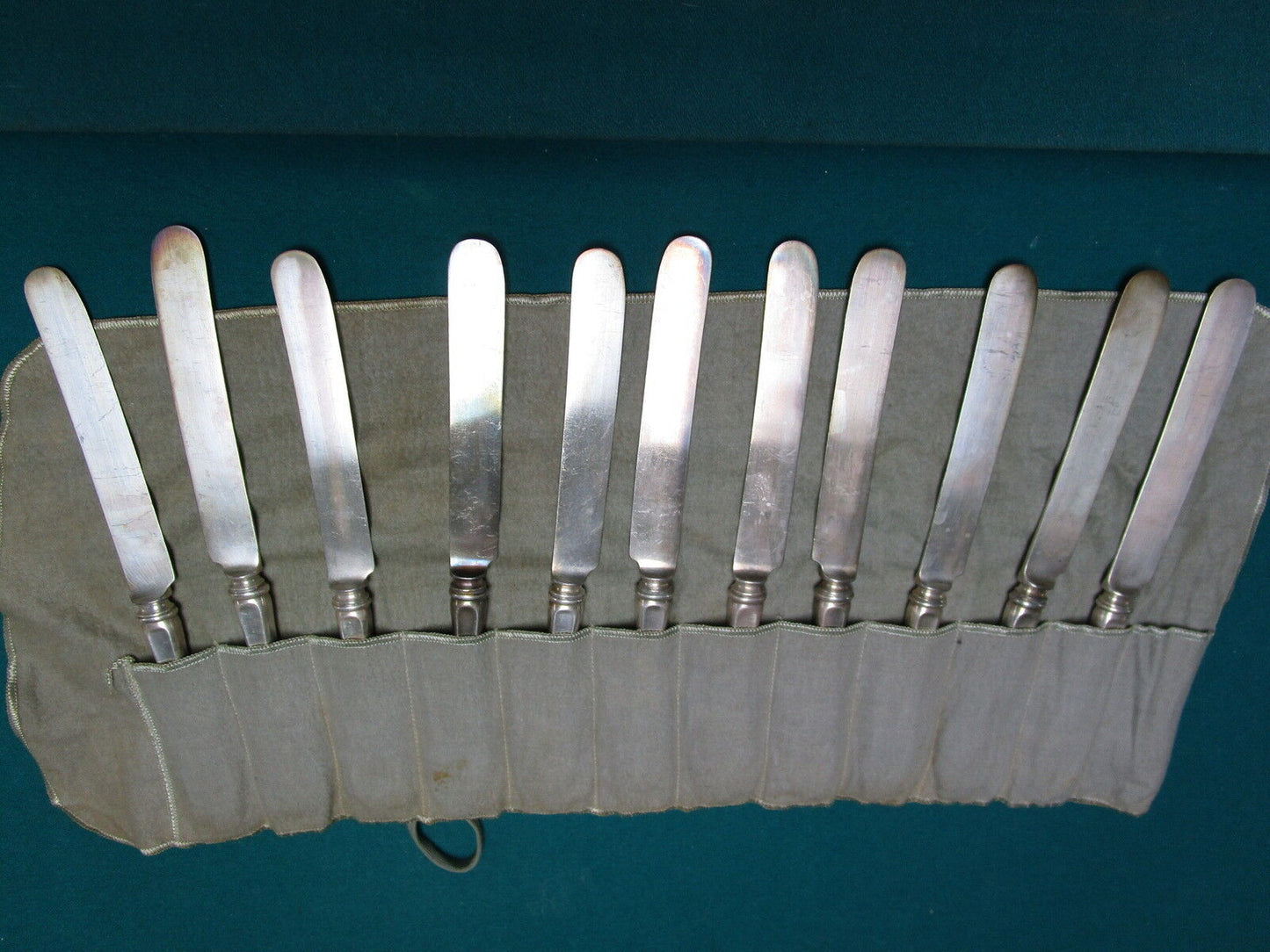 Vintage 11 unmarked  silverplate knives in velvet cover