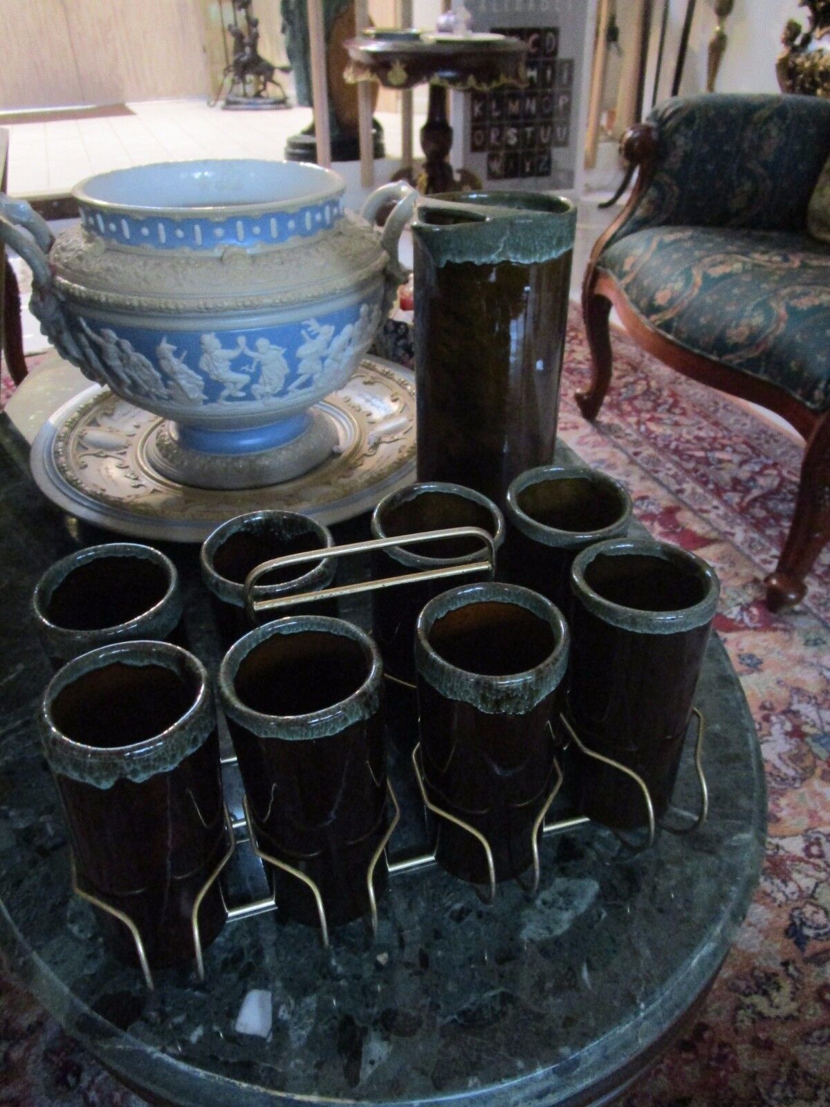 VAN BRIGGLE SET OF PITCHER AND 8 TUMBLERS IN METAL STAND