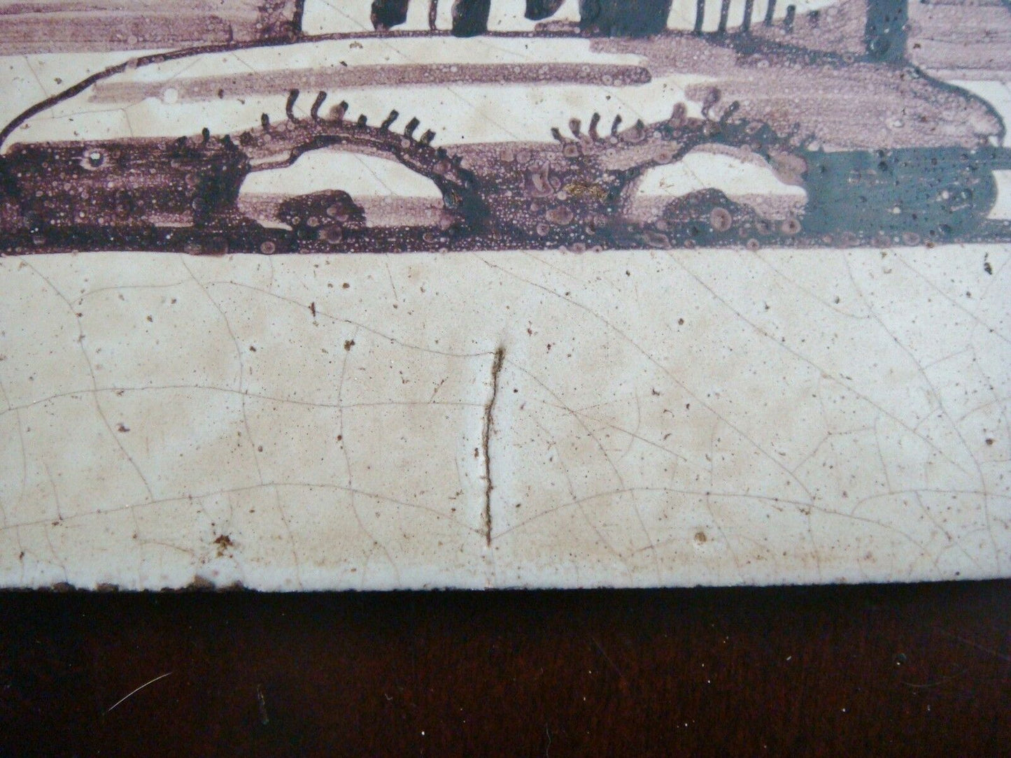 18th century salvaged Delft manganese tile depicting buildings in seashore