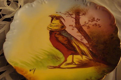 Old German plate decorated with birdsm, molded and ruffled borders, gold guild