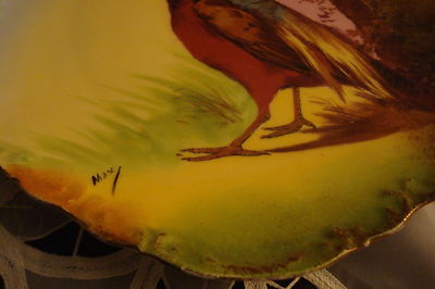 Old German plate decorated with birdsm, molded and ruffled borders, gold guild